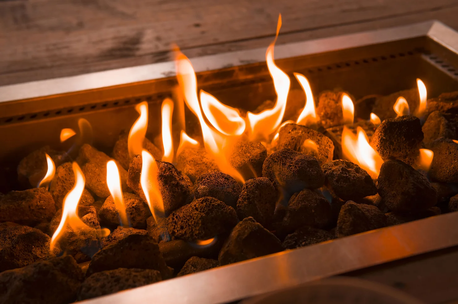 a gas fireplace with open flames heats a home while the vernon bc homeowner has the furnace maintained